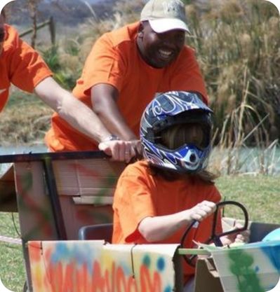 man pushing soap box derby